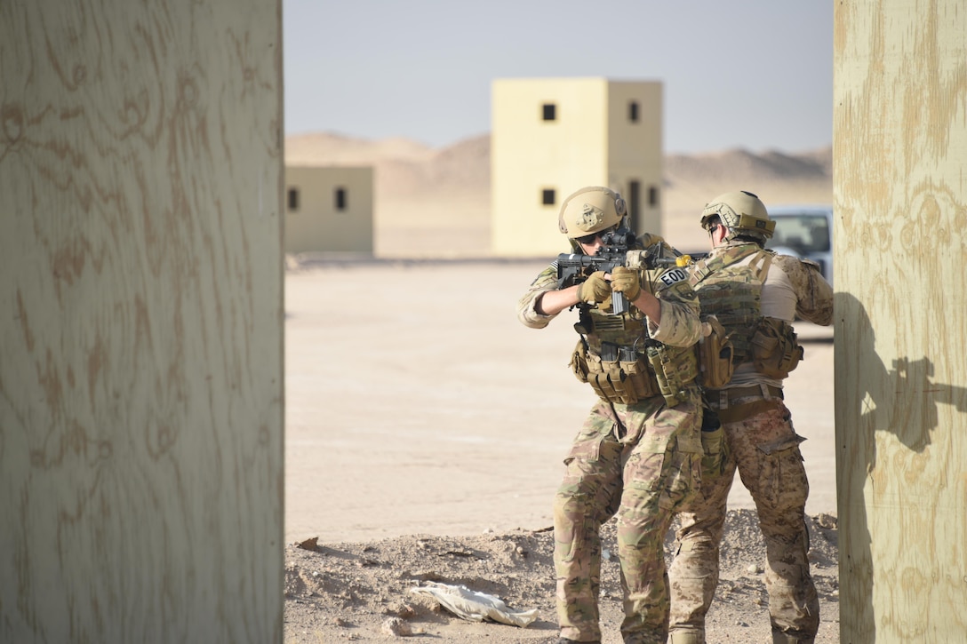 A pair of Air Force and Navy explosive ordnance disposal technicians work together to cover one another during a joint service EOD field training exercise at an undisclosed location in Southwest Asia, May 23, 2017. EOD teams from each of the four service branches, deployed to five different countries across the AOR, gathered for joint service EOD training, which allowed for the exchange of tactics, techniques and procedures between service branches. (U.S. Air Force photo/Tech. Sgt. Jonathan Hehnly)