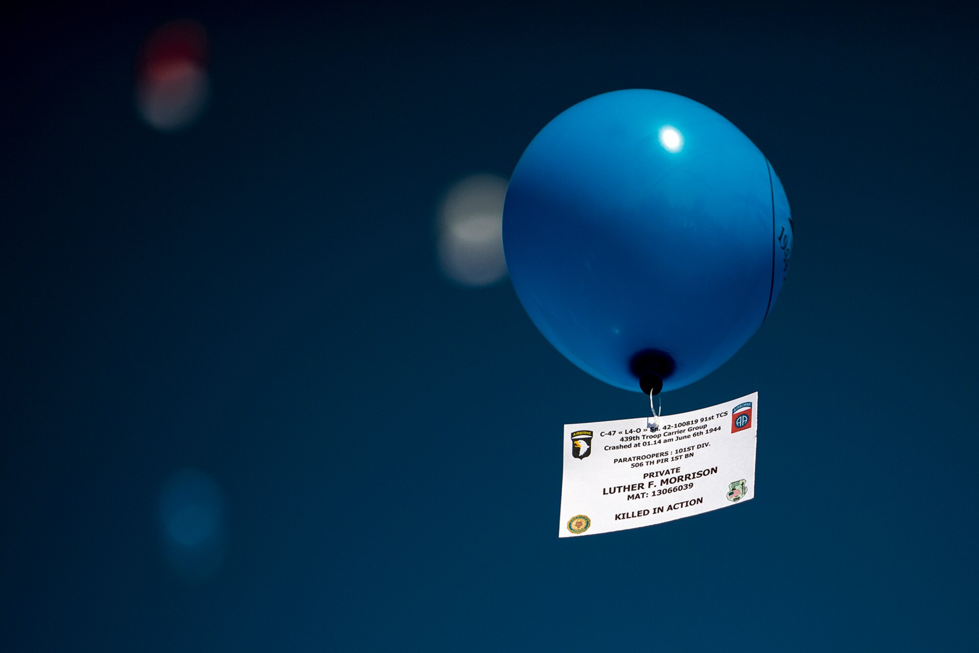 A placard tied to a balloon reads “Private Luther F. Morrison...Killed In Action,” as it floats into the sky during a D-Day remembrance ceremony at the United States Army Air Forces Transport Memorial in Picauville, France, June 1, 2017. French children released the balloons to honor the fallen of the Normandy D-Day landings 73 years ago. This event commemorates the 73rd anniversary of D-Day, the largest multinational amphibious landing and operational military airdrop in history, and highlights the U.S.' steadfast commitment to European allies and partners. Overall, approximately 400 U.S. service members from units in Europe and the U.S. are participating in ceremonial D-Day 73 events from May 31-June 7, 2017. (U.S. Air Force photo by Senior Airman Devin Boyer) 