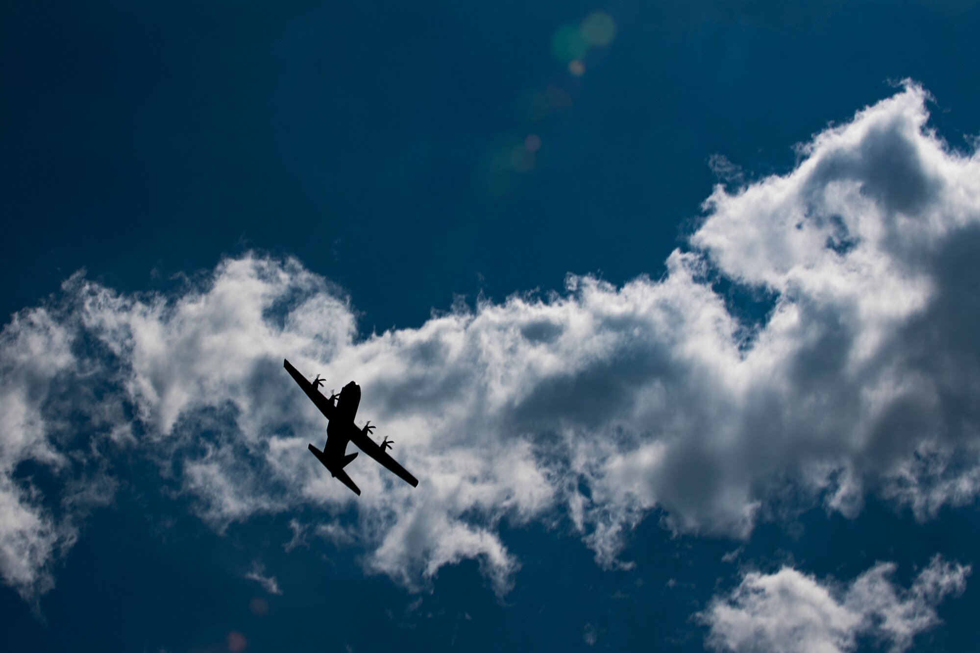A U.S. Air Force C-130J Super Hercules assigned to the 37th Airlift Squadron at Ramstein Air Base, Germany, flies over Coigny, France, during a D-Day remembrance ceremony, June 1, 2017. The 37th AS engaged in combat operations by dropping paratroopers into Normandy on D-Day 73 years ago. This event commemorates the 73rd anniversary of D-Day, the largest multinational amphibious landing and operational military airdrop in history, and highlights the U.S.' steadfast commitment to European allies and partners. Overall, approximately 400 U.S. service members from units in Europe and the U.S. are participating in ceremonial D-Day 73 events from May 31-June 7, 2017. (U.S. Air Force photo by Senior Airman Devin Boyer) 