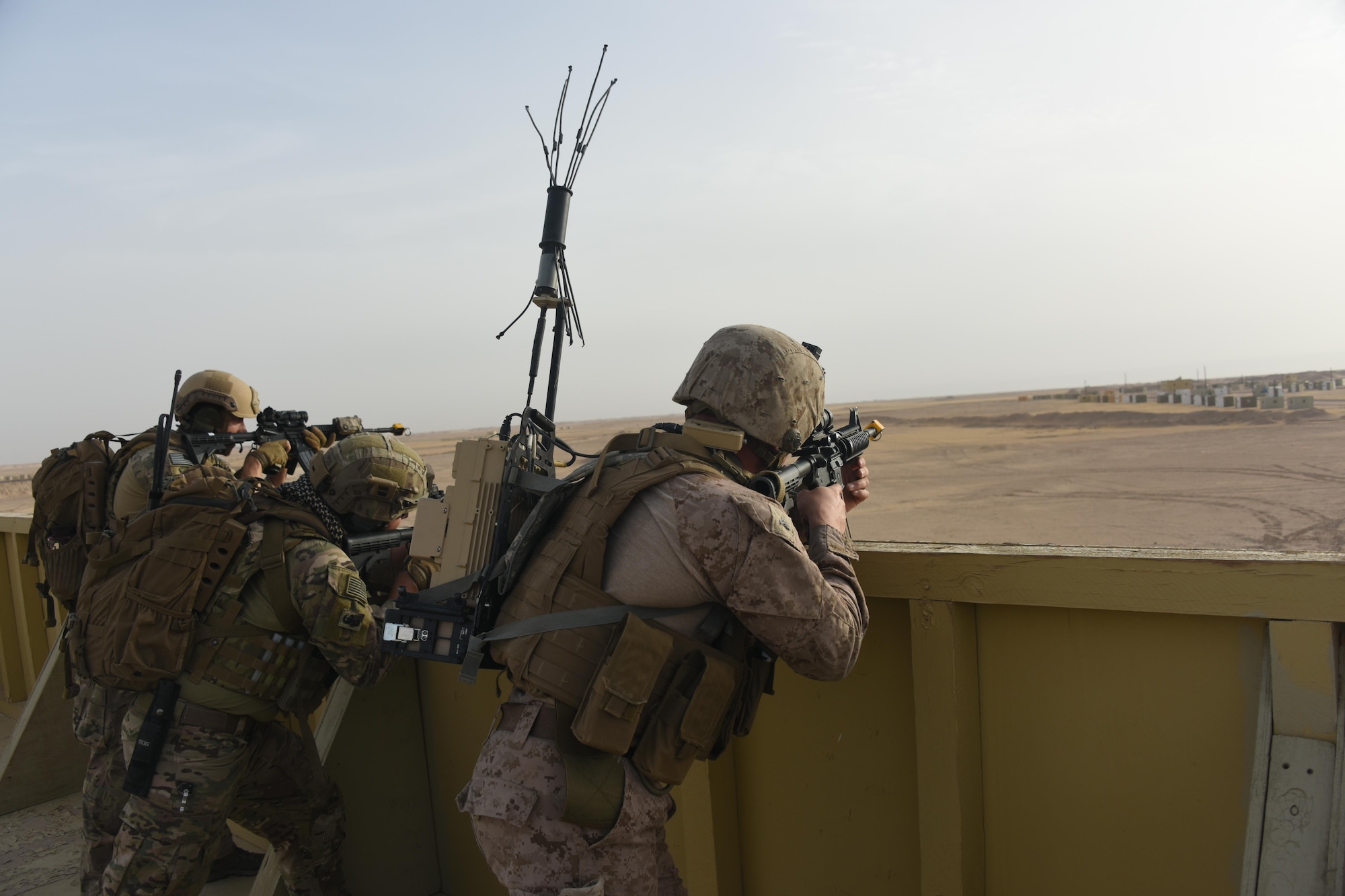 Air Force and Marine explosive ordnance disposal technicians work together to provide overwatch for advancing EOD teams during a joint service EOD field training exercise at an undisclosed location in Southwest Asia, May 25, 2017. EOD teams from each of the four service branches, deployed to five different countries across the AOR, gathered for joint service EOD training, which allowed for the exchange of tactics, techniques and procedures between service branches. (U.S. Air Force photo/Tech. Sgt. Jonathan Hehnly)