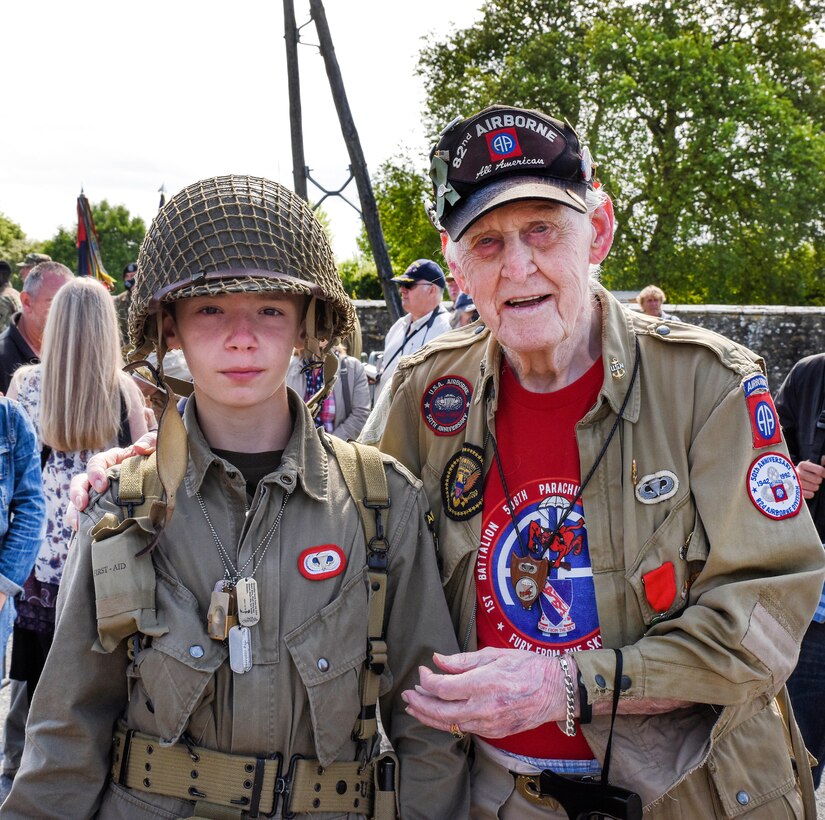 World War II veteran Ernie Lamson poses for a photo with a young historical re-enactor before a memorial ceremony in Angoville-au-Plain, France, June 3, 2017. Army photo by Staff Sgt. Tamika Dillard