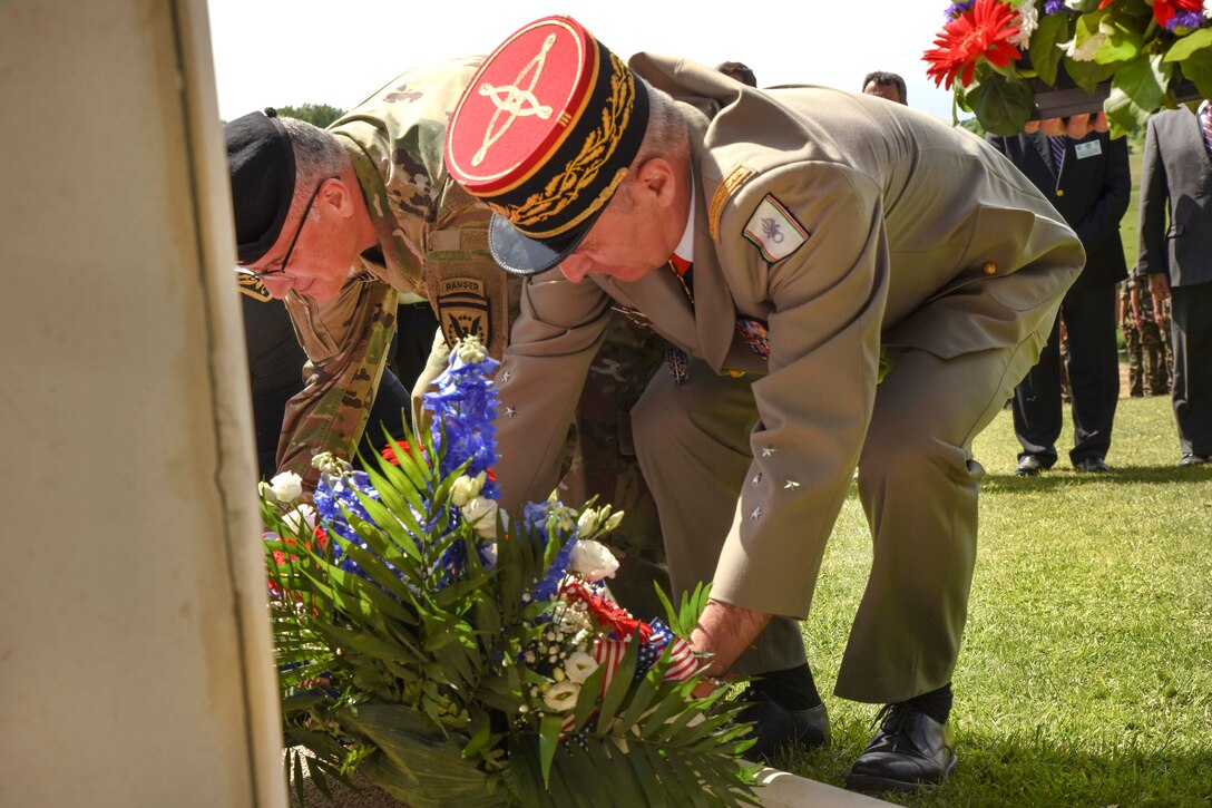 Army Gen. Curtis Scaparrotti, left, commander of U.S. European Command and NATO's supreme allied commander for Europe, and Lt. Gen. Christophe de Saint Chamas, General Officer of Defense and Security Zone West, place a wreath at the foot of the ‘Iron Mike’ statue in Sainte-Mere-Eglise, France, June 4, 2017.
