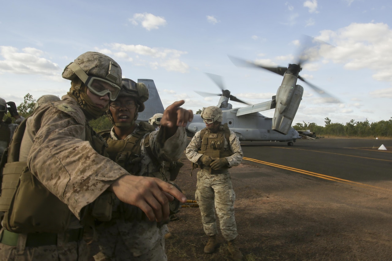Marine Corps Sgt. Reza Soendoro, center, directs Lance Cpl. Nicholas Pierce during an external lift exercise at Mount Bundey Training Area near Darwin, Australia, May 26, 2017. Soendoro is a landing support chief with the 7th Engineer Support Battalion, and Pierce is a landing support specialist with Headquarters and Service Company, 3rd Battalion, 4th Marine Regiment. The landing support specialists worked as a helicopter support team to transport and place targets for future training. Marine Corps photo by Sgt. Emmanuel Ramos