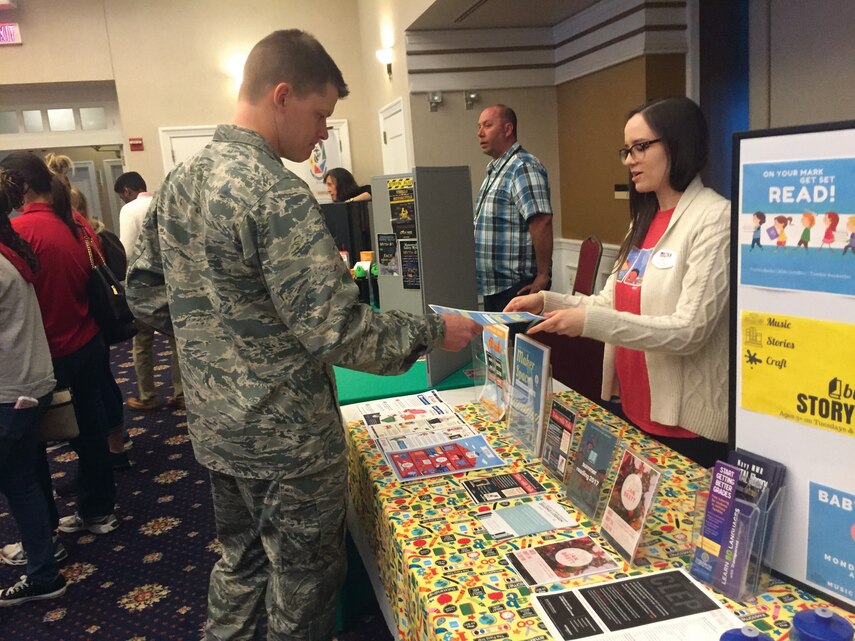 Katelyn, a library technician at Marine Corps Base Quantico library speaks with an airmen about their summer reading program, Reading by Design, expected to take place June 19-July 28. The event inspired by the creativity of artists and architects will feature programs for all aboard base, both child and adult, to encourage and support a continued love for reading. Registration begins June 1 at QuanticoBase.beanstack.org.