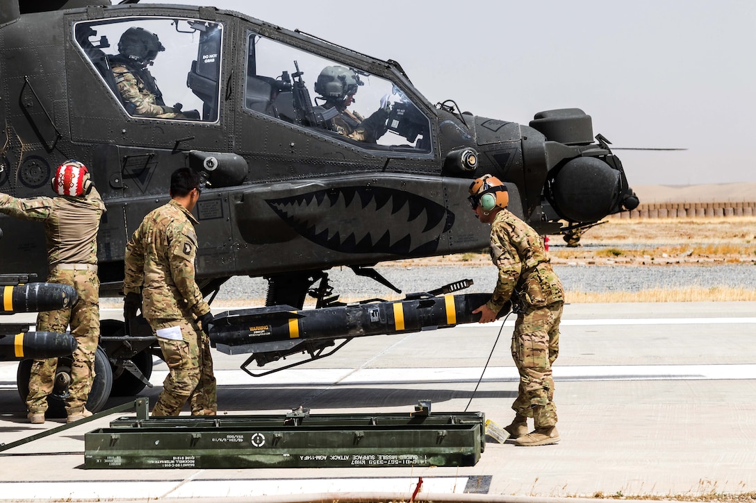 Soldiers load an AGM-114 Hellfire missile onto an AH-64E Apache helicopter before a mission in Kunduz, Afghanistan, May 31, 2017. Army photo by Capt. Brian Harris