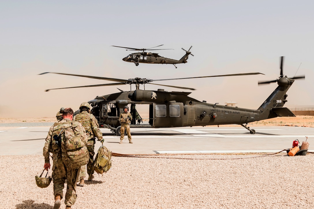 An Army crew chief directs passengers as they board a UH-60 Black Hawk helicopter in Kunduz, Afghanistan, May 31, 2017. Army photo by Capt. Brian Harris