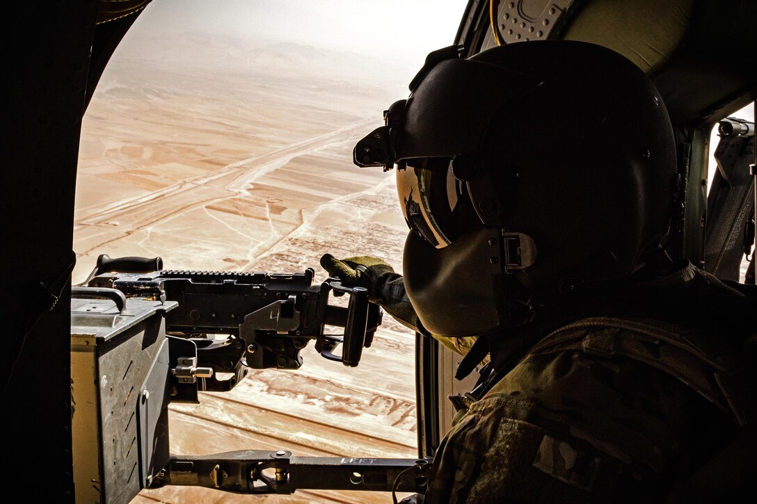 An Army crew chief scans the terrain from a UH-60 Black Hawk helicopter during a flight near Kunduz, Afghanistan, May 31, 2017. Army photo by Capt. Brian Harris