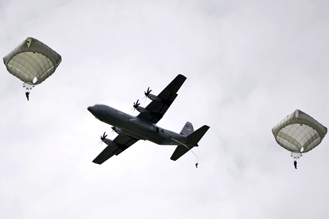 Paratroopers jump out of an aircraft during an airborne operation to commemorate D-Day in Sainte-Mere-Eglise, France, June 4, 2017. Air Force photo by Airman 1st Class Alexis C. Schultz 