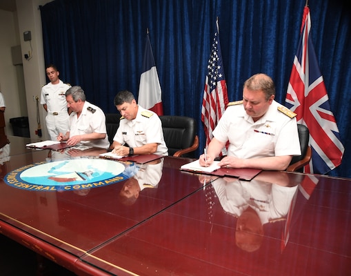 MANAMA, Bahrain (June 1, 2017) Vice Adm. Louis-Michel Guillaume, left, commander of French Submarine and Strategic Oceanic Forces, Vice Adm. Kevin M. Donegan, middle, commander of the U.S. Naval Forces Central Command, and Rear Adm. Robert K. Tarrant, commander Operations of the Royal Navy, sign an agreement to increase coordination for anti-submarine warfare activities between France, the U.S. and the United Kingdom. The agreement follows the signing of a trilateral cooperation agreement by Chief of Naval Operations Adm. John Richardson, the First Sea Lord of the United Kingdom Adm. Sir Philip Jones and French Chief of Naval Staff Adm. Christophe Prazuck in London on March 27. (U.S. Navy photo by Mass Communications Specialist 2nd Class Victoria Kinney/Released) (Photo by MC2 Victoria Kinney)