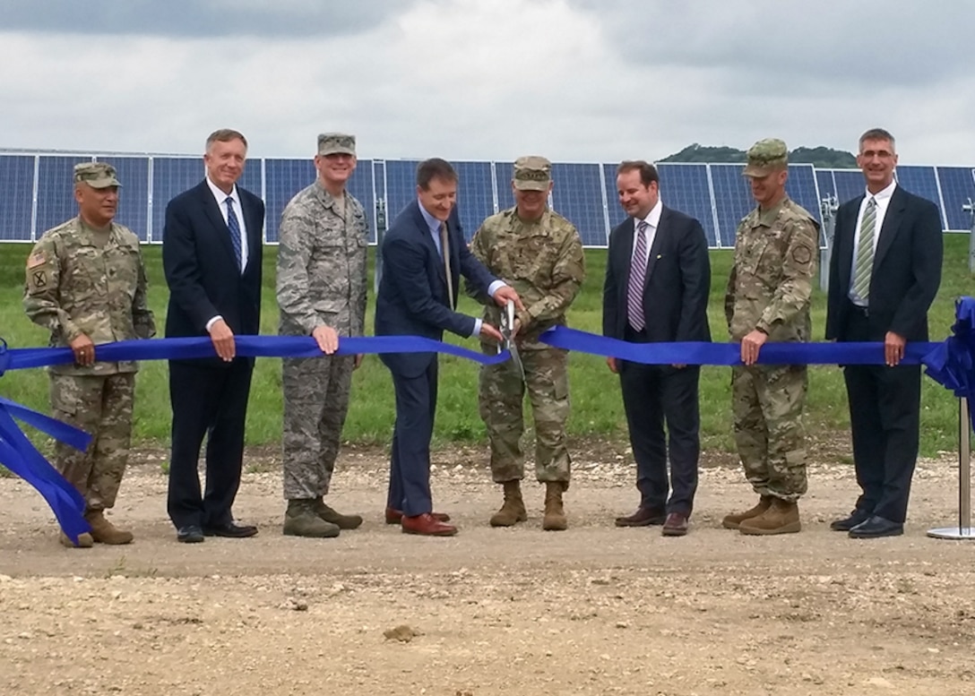 Defense Logistics Agency Energy Commander Air Force Brig. Gen. Martin Chapin (third from left] and other stakeholders participate in a ribbon-cutting ceremony with other senior officials for the large-scale
renewable energy solar project at Fort Hood, Texas, June 2. 
