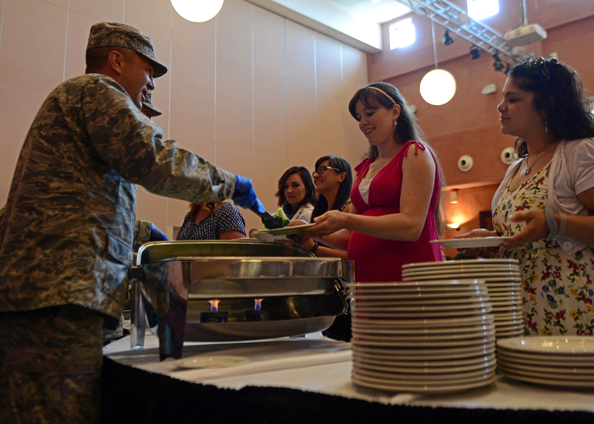Col. Matthew Kmon, 31st Maintenance Group Commander, serves lunch to spouses during a spouse appreciation lunch, at Aviano Air Base, Italy, June 1, 2017. The Airman and Family Readiness Center coordinated the lunch to recognize spouses for their sacrifices. (U.S. Air Force photo by Airman 1st Class Ryan Brooks)