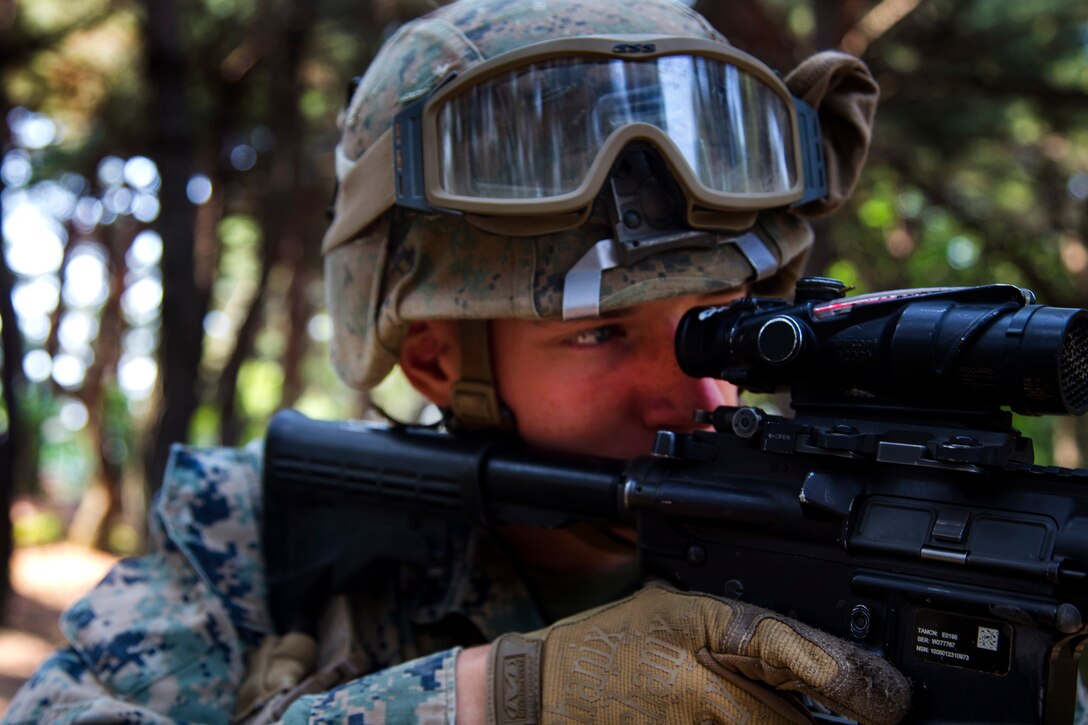A Marine aims a weapon before engaging targets in a small unit leadership building course at Camp Mujuk, South Korea, May 29, 2017. Marine Corps photo by Lance Cpl. Caleb T. Maher