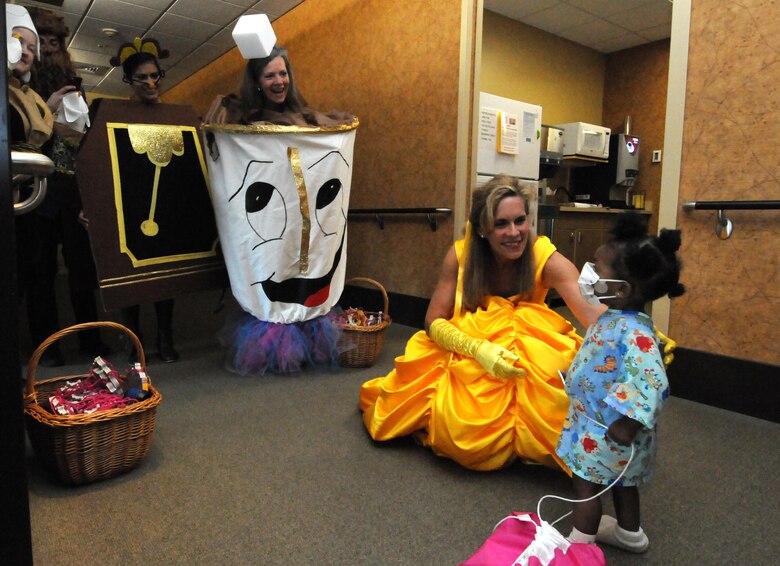 Schriever volunteers dressed as fairy tale characters greet Nyomi Ollie, 1, during a visit to Penrose-St. Francis Hospital in Colorado Springs, Colorado, June 1, 2017. The event was part of an initiative to bring cheer to sick children by bringing magic to their day. (U.S. Air Force photo/Staff Sgt. Wes Wright)