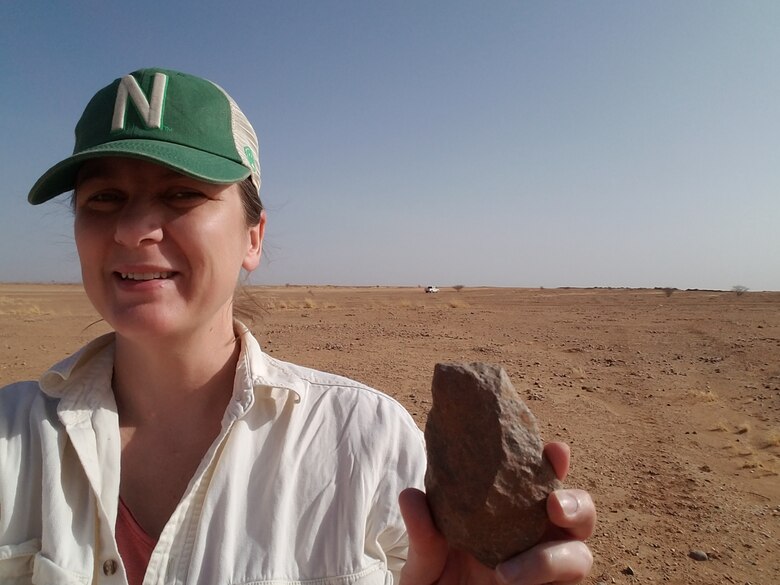 U.S. Army Corps of Engineers Archaeologists Amy Williams displays one of the Acheulean hand axes found in the Nigerien desert that can be dated to more than 1 million years ago. Three hand axes were discovered during a cultural survey of an international air base under construction.