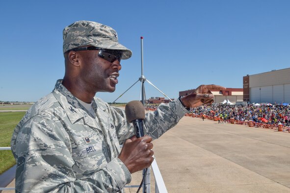 Col. Kenyon Bell, 72nd Air Base commander, emphasizes the importance of community support to the base while giving opening remarks during Tinker Air Force Base's Star Spangled Salute air show May 21, 2017, Tinker Air Force Base, Oklahoma. Col. Bell addressed the record-breaking crowd from the raised announcers booth at air show center. (U.S. Air Force photo/Greg L. Davis)