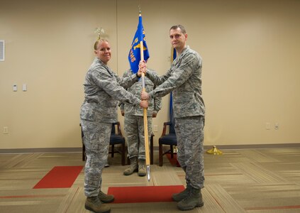 Col. Lori Walden, 622nd Civil Engineering Group commander, passes the the 560th RED HORSE Squadron guideon to the unit's new commander, Lt. Col. Horace Jones during an assumption of command ceremony June 3, 2017 at Joint Base Charleston, South Carolina. (U.S. Air Force Photo/Senior Airman Tom Brading)