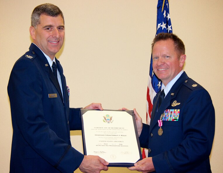 Col. Richard Eccher, a former pilot at the 932nd Airlift Wing and returning guest speaker, presents a certificate of retirement to Lt. Col. Robert Witzel during a special ceremony held June 4, 2017, at Scott Air Force Base, Illinois.  Witzel retires as the Chief of Tactics, 932nd Operations Support Flight, 73rd Airlift Squadron, under the 932nd Airlift Wing.  He is a command pilot with more than 8,500 flying hours in several aircraft including the C-141, the C-9 and finally the C-40C plane belonging to the Illinois wing, aligned under 22nd Air Force, and the Air Force Reserve Command.  (U.S. Air Force photo by Lt. Col. Stan Paregien)