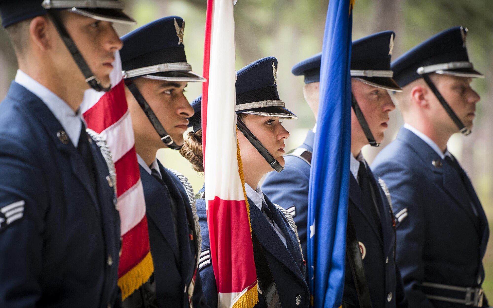 A color guard stands at parade rest prior to the Team Eglin Honor Guard graduation ceremony at Eglin Air Force Base, Fla., June 1. Approximately 12 new Airmen graduated from the 120-plus-hour course. The graduation performance includes flag detail, rifle volley, pall bearers and bugler for friends, family and unit commanders. (U.S. Air Force photo/Samuel King Jr.)