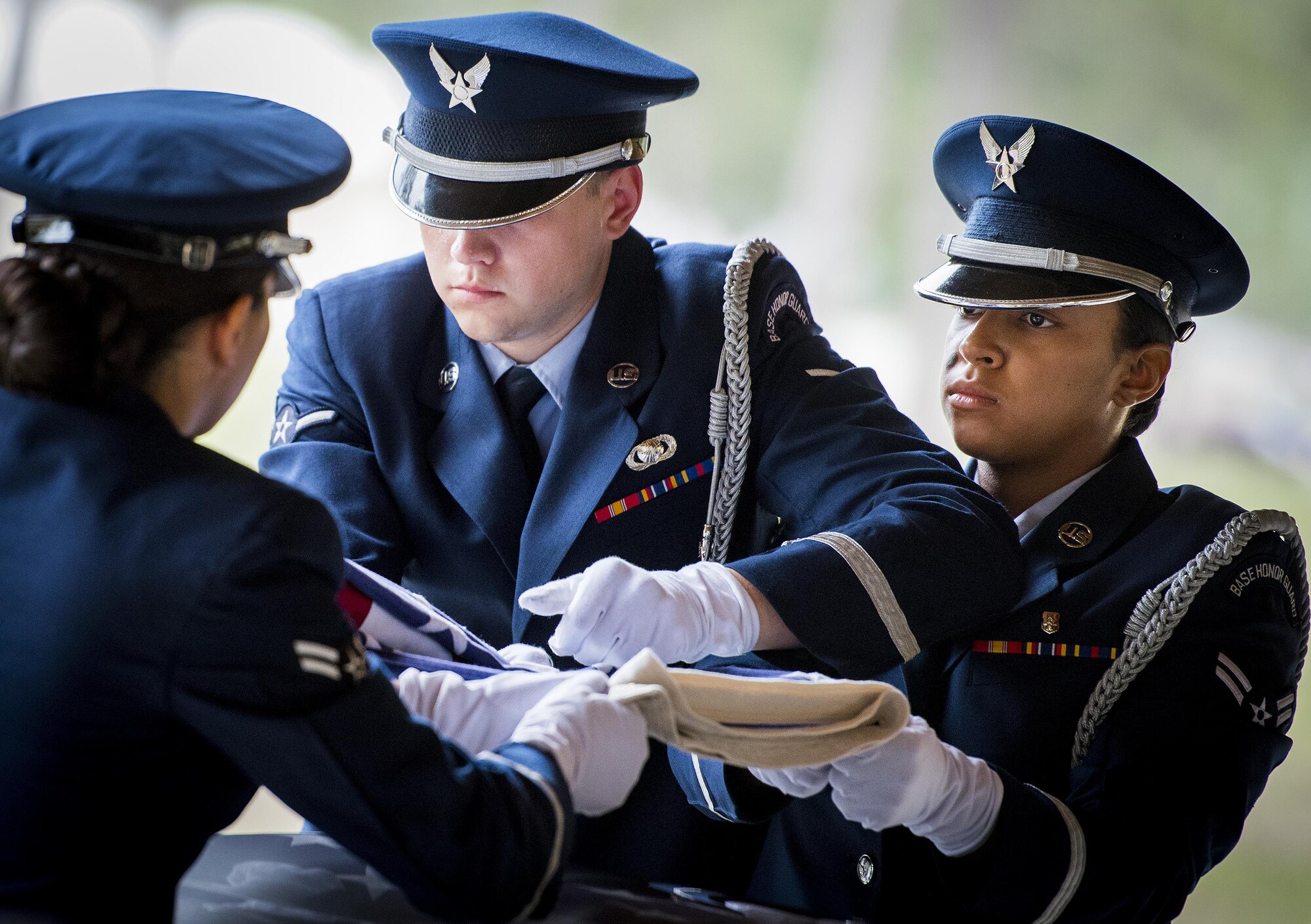 New Honor Guard members perform the flag-folding detail of the unit’s graduation ceremony at Eglin Air Force Base, Fla., June 1. Approximately 12 new Airmen graduated from the 120-plus-hour course. The graduation performance includes flag detail, rifle volley, pall bearers and bugler for friends, family and unit commanders. (U.S. Air Force photo/Samuel King Jr.)