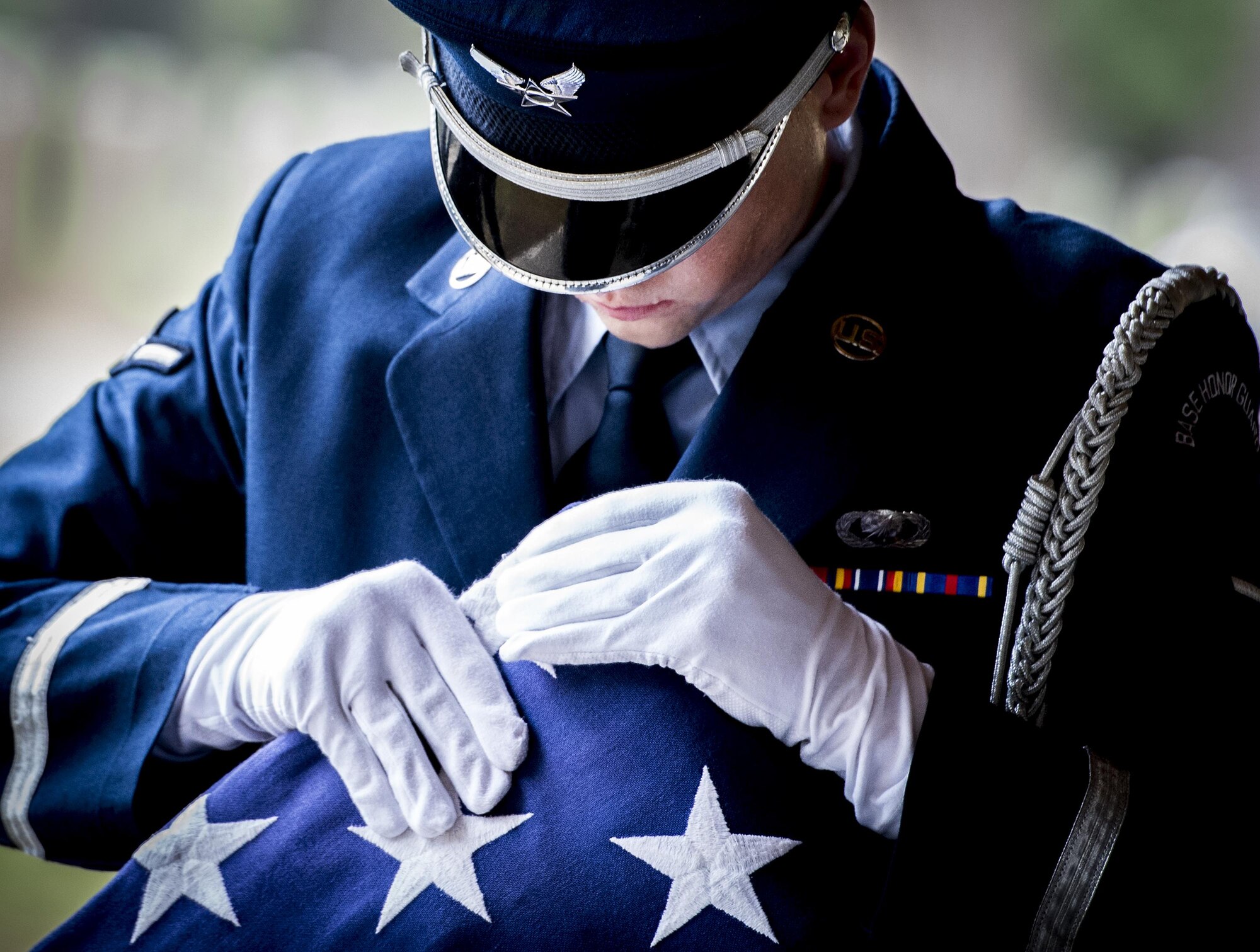 Airman Kyle Kruger, 96th Comptroller Squadron, ensures the flag is properly folded during the funeral detail portion of the Honor Guard graduation ceremony at Eglin Air Force Base, Fla., June 1. Approximately 12 new Airmen graduated from the 120-plus-hour course. The graduation performance includes flag detail, rifle volley, pall bearers and bugler for friends, family and unit commanders. (U.S. Air Force photo/Samuel King Jr.)