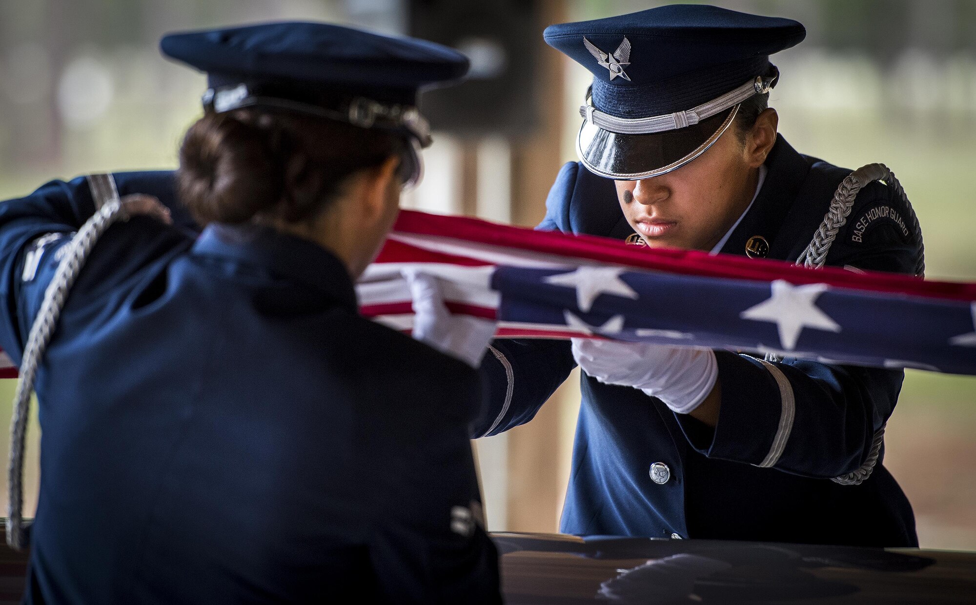 Airman 1st Class Emily Delacruz, 96th Medical Group, performs the flag-folding detail of the Honor Guard graduation ceremony at Eglin Air Force Base, Fla., June 1. Approximately 12 new Airmen graduated from the 120-plus-hour course. The graduation performance includes flag detail, rifle volley, pall bearers and bugler for friends, family and unit commanders. (U.S. Air Force photo/Samuel King Jr.)