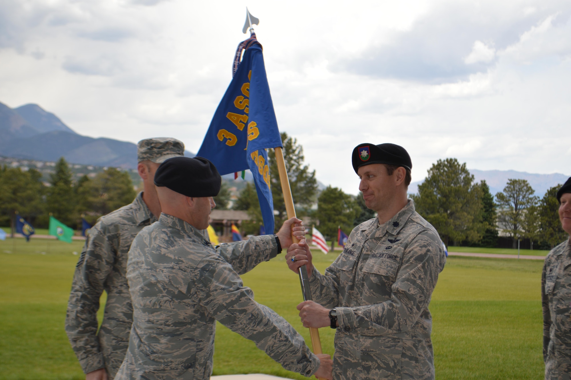Lt. Col. Jeffrey P. Strange accepts the 13th Air Support Operations Squadron guidon from Col. Aaron Ullman, commander, 3rd Air Support Operations Group, Fort Hood, Texas, during a change of command ceremony at Founders Field, May 30, 2017, Fort Carson, Colo.  Strange assumes command the squadron after Lt. Col. John W. Blocher relinquished it. (U.S. Army photo by Dani Johnson) 