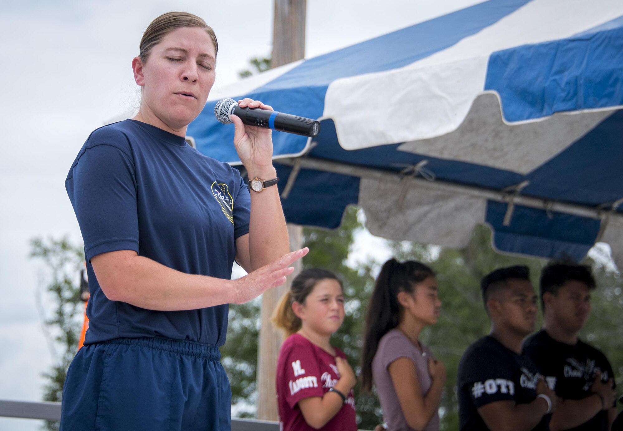 Tech. Sgt. Jennifer Wooten, 16th Electronic Warfare Squadron, sings the National Anthem to kick off the Eglin Connects event at Eglin Air Force Base, Fla., June 2.  The event to help promote resiliency featured information booths, sporting events and a car show.  (U.S. Air Force photo/Samuel King Jr.)