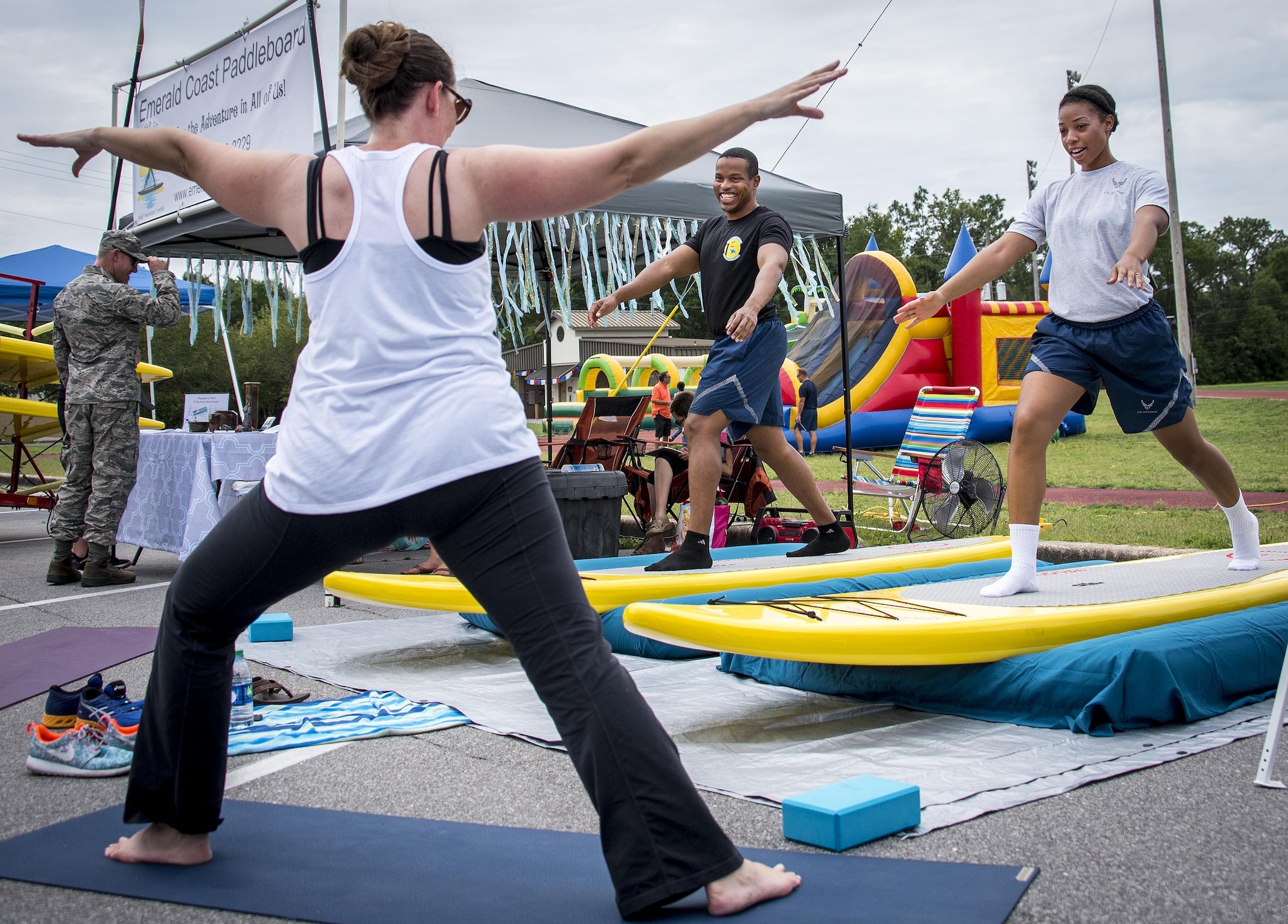 Airmen receive an on-land paddleboard lesson during the Eglin Connects event at Eglin Air Force Base, Fla., June 2.  The event to help promote resiliency featured information booths, sporting events and a car show.  (U.S. Air Force photo/Samuel King Jr.)