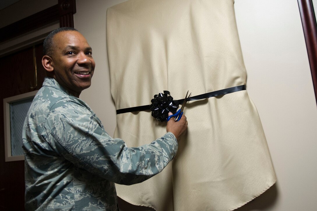 Maj. Gen. Roosevelt Allen Jr. cuts the ribbon for an unveiling of his portrait as former 79th Medical Wing Commander on Joint Base Andrews June 2, 2017. (Photo by Senior Master Sgt. Adrian Cadiz)(Released)