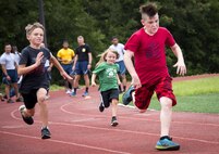 Children sprint toward the finish line during one of the foot races that were part of the Eglin Connects event at Eglin Air Force Base, Fla., June 2.  The event to help promote resiliency featured information booths, sporting events and a car show.  (U.S. Air Force photo/Samuel King Jr.)