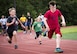 Children sprint toward the finish line during one of the foot races that were part of the Eglin Connects event at Eglin Air Force Base, Fla., June 2.  The event to help promote resiliency featured information booths, sporting events and a car show.  (U.S. Air Force photo/Samuel King Jr.)