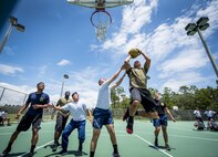 An Airman goes up for a shot at the 3-on-3 basketball tournament that was part of the Eglin Connects event at Eglin Air Force Base, Fla., June 2.  The event to help promote resiliency featured information booths, sporting events and a car show.  (U.S. Air Force photo/Samuel King Jr.)