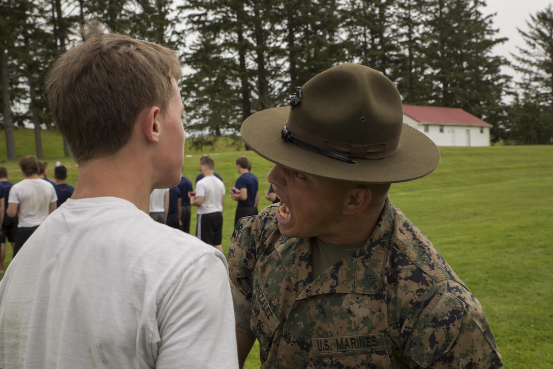 Drill Instructor Sgt. Kelvin Gonzalez, Support Battalion, MCRD San Diego, encourages a Poolee at the RS Portland Annual Pool Function. Poolees within RS Portland gathered at Camp Rilea, Warrenton, Oregon, for an annual 3-day field meet. Poolees were given an opportunity to experience aspects of recruit training to include drill instructors, and physical training. (U.S. Marine Corps Photo by Sgt. Taylor Morton/Released) 