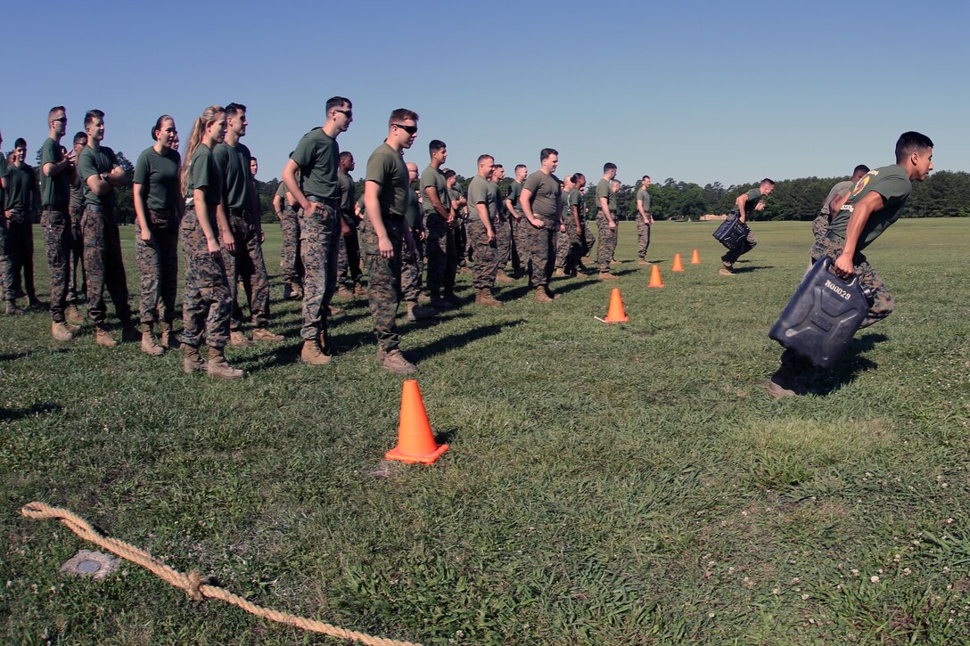Marines with Marine Aircraft Group 29, 2nd Marine Aircraft Wing, participate in a water jug relay race during a semi-annual field meet at Marine Corps Air Station New River, N.C., May 26, 2017. The race was part of the unit’s field meet in preperation for the Memorial Day weekend. Alongside the events, MAG-29 conducted classes and guided discussions to assist Marines with identifying and preparing to mitigate upcoming risk during the summer months. (U.S. Marine Corps photo by Pfc. Skyler Pumphret/Released)