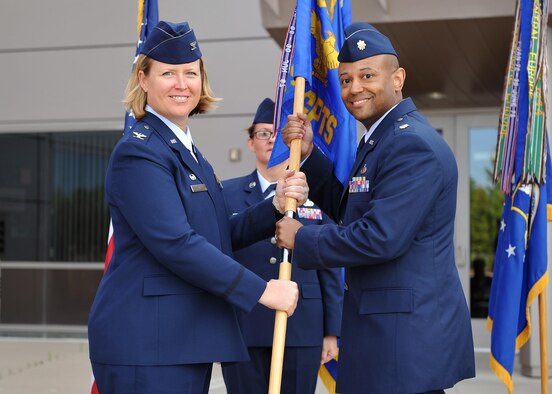 Col. DeAnna Burt, 50th Space Wing commander, welcomes Maj. Stephen Cash to command during the 50th Somptroller Squadron change of command cerremony at Schriever Air Force Base, Colorado, Friday, June 2, 2017. Cash assumed command from 
 Maj. Latoya Smith. (U.S. Air Force Photo/Dennis Rogers)