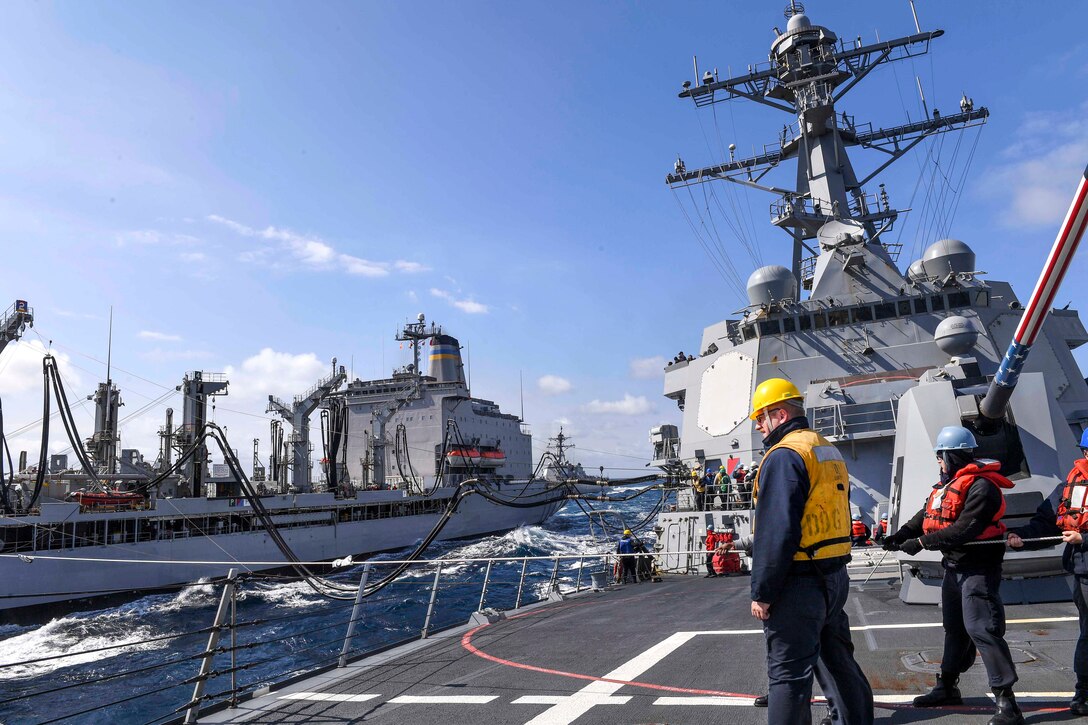 Sailors aboard the Arleigh Burke-class guided-missile destroyer USS Wayne E. Meyer conduct a replenishment with fleet replenishment oiler USNS Rappahannock as the Arleigh Burke-class guided-missile destroyer USS Mustin approaches in the Pacific Ocean, May 26, 2017. Navy photo by Petty Officer 3rd Class Kelsey L. Adams 
