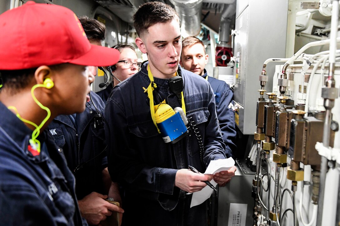 Navy Petty Officer 1st Class Christy Edwards teaches engineering watch standers about proper halon actuation procedures during a drill aboard the Arleigh Burke-class guided-missile destroyer USS Wayne E. Meyer in the Pacific Ocean, May 30, 2017. Edwards is a damage controlman. Navy photo by Petty Officer 3rd Class Kelsey L. Adams