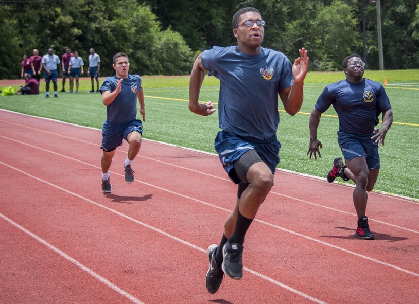 Airmen sprint toward the finish line during one of the foot races that were part of the Eglin Connects event at Eglin Air Force Base, Fla., June 2.  The event to help promote resiliency feature information booths, sporting events and a car show.  (U.S. Air Force photo/Samuel King Jr.)
