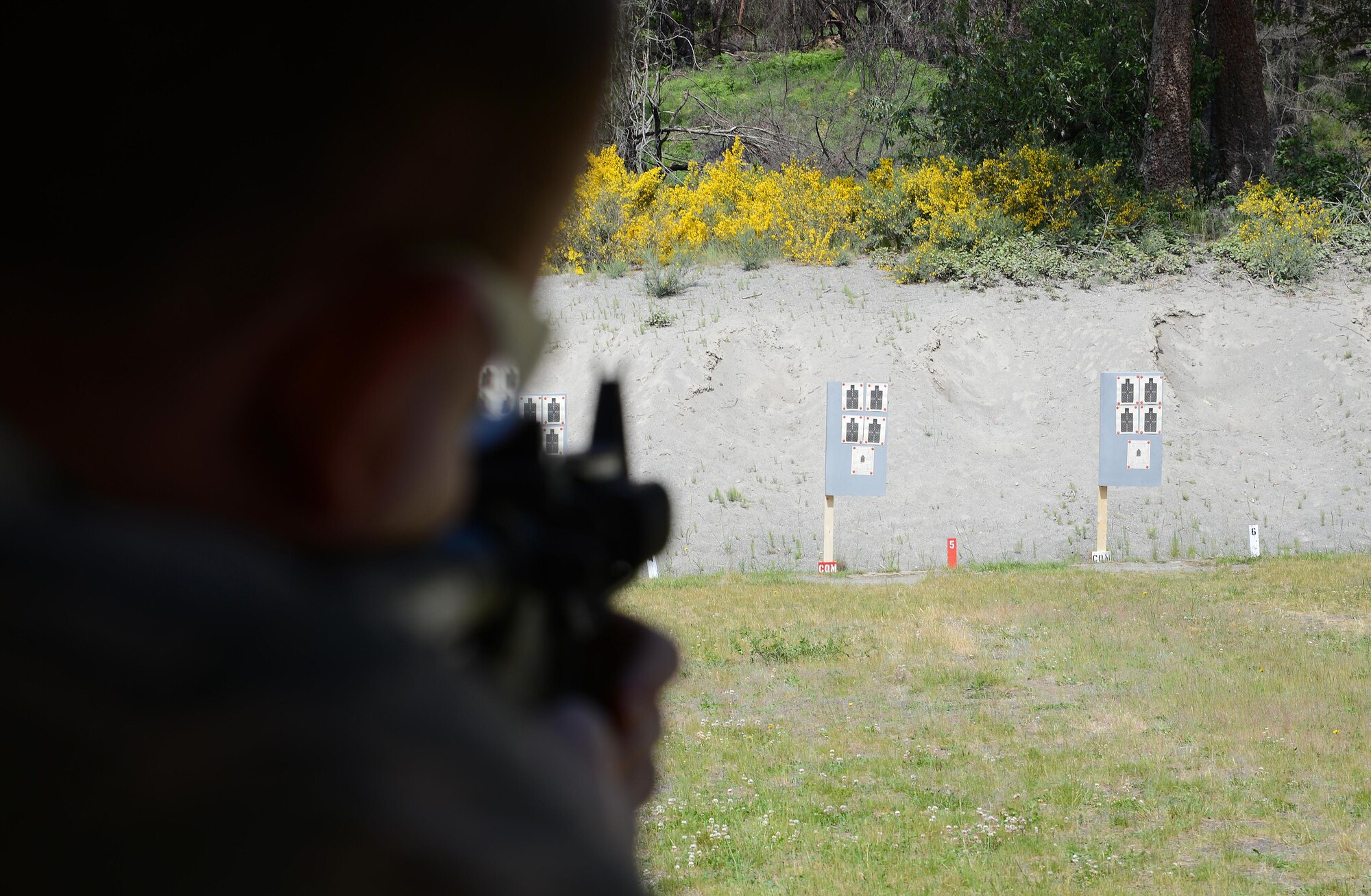 Staff Sgt. Blake McCartney, 627th Security Forces Squadron command support staff, aims an M-4 Carbine rifle at a target May 31, 2017, during the Elementary Level Rifle Excellence Competition at Joint Base Lewis-McChord, Wash. More than 100 Airmen from JBLM competed in the competition for the U.S. Air Force Excellence in Competition Rifleman Badge. (U.S. Air Force photo/Senior Airman Jacob Jimenez)  
