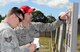 Staff Sgt. Daniel Watkins (right), 627th Security Forces Squadron combat arms instructor, shows Staff Sgt. Carl Kocon, 7th Airlift Squadron loadmasters, what areas of a target he hit, during the Elementary Level Rifle Excellence Competition May 31, 2017, at Joint Base Lewis-McChord, Wash. The competition was hosted by the 627th SFS combat arms section and is the second competition of its kind to be held at JBLM. (U. S. Air Force photo/Senior Airman Jacob Jimenez) 