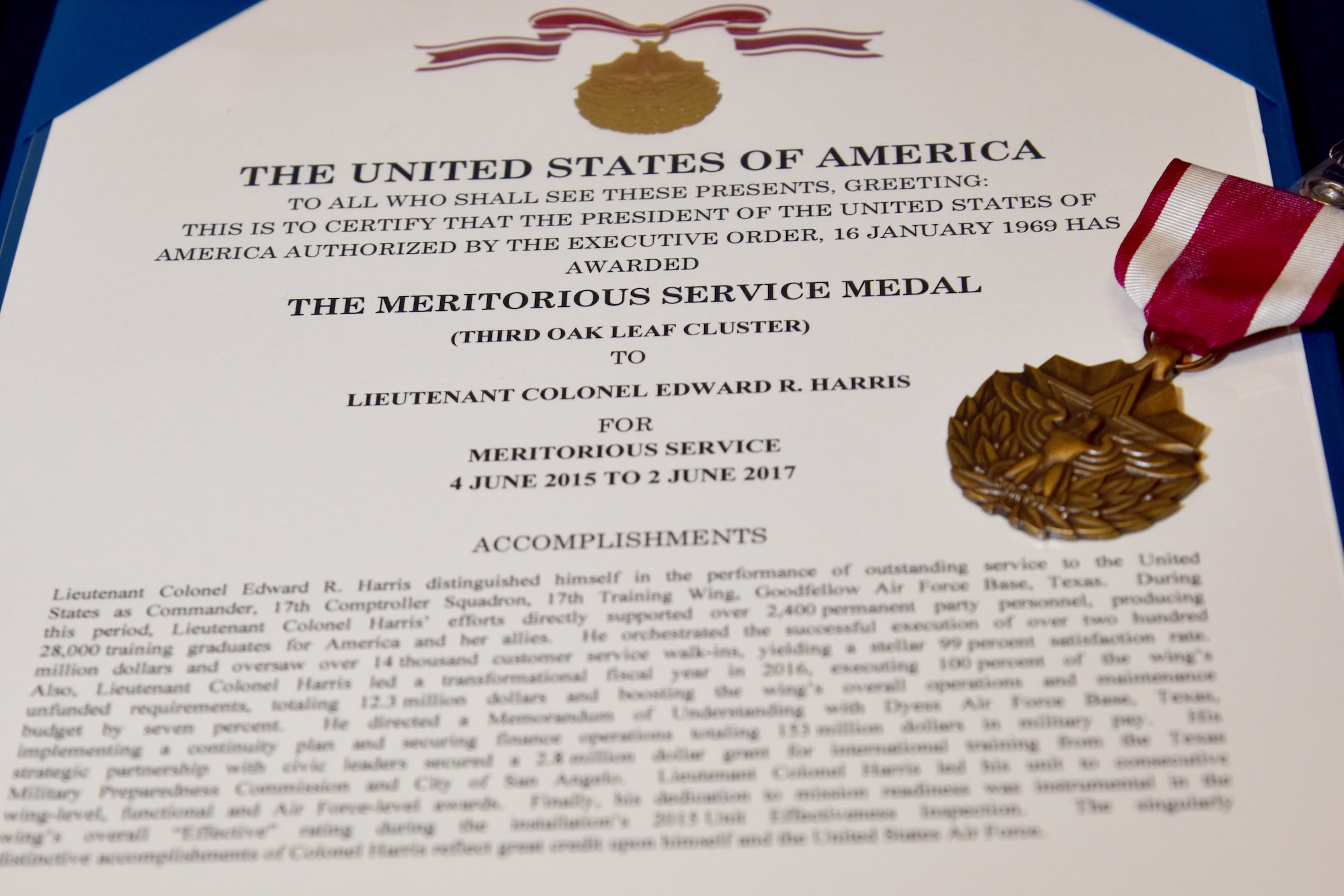 The Meritorious Service medal and certificate for U.S. Air Force Lt. Col. Edward Harris, 17th Comptroller Squadron Commander, during the 17th CPTS Change of Command ceremony at the Event Center on Goodfellow Air Force Base, Texas, May 31, 2017. Harris received the award in honor of his work as the commander before passing the command down. (U.S. Air Force photo by Staff Sgt. Joshua Edwards/Released)