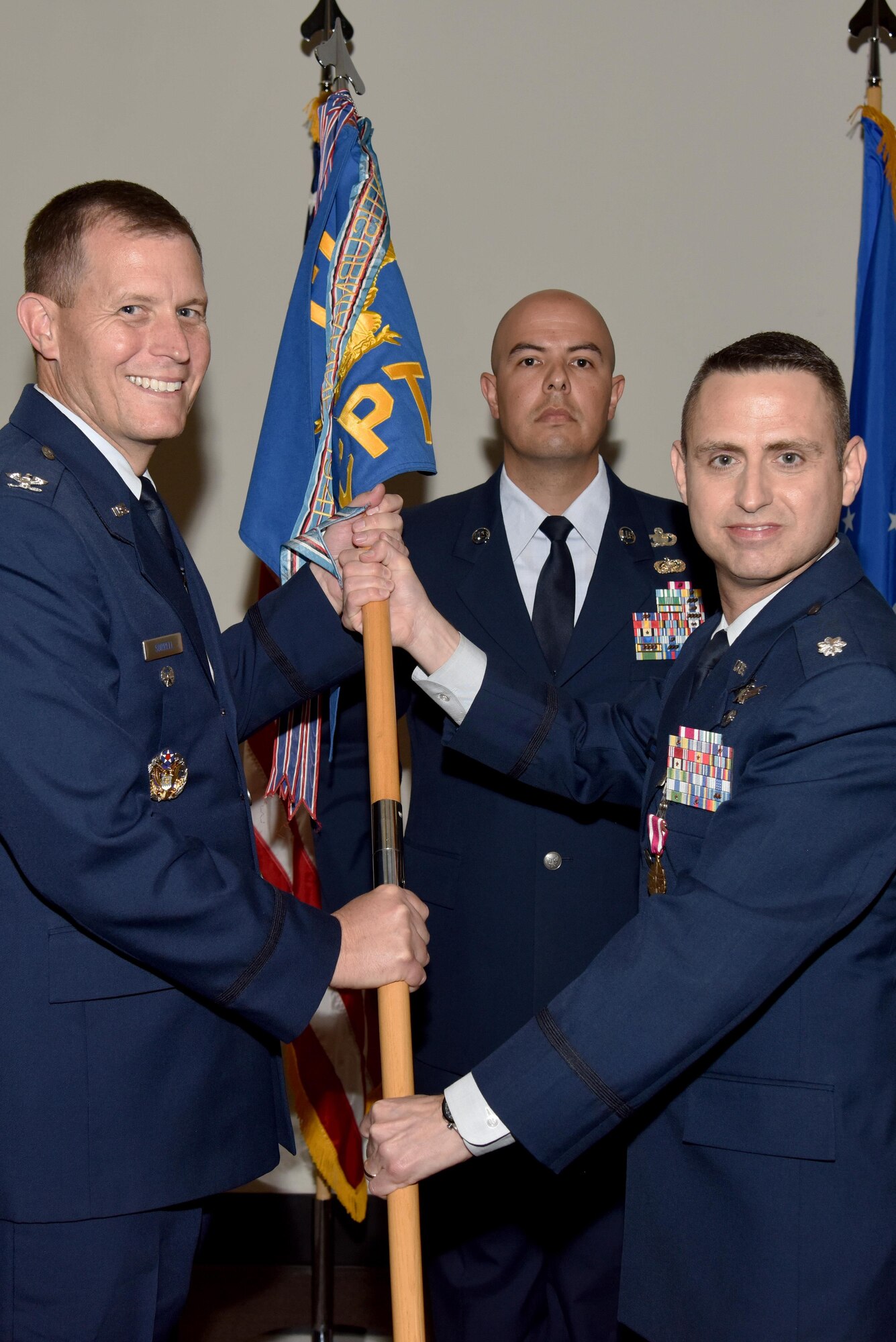 U.S. Air Force Lt. Col. Edward Harris, 17th Comptroller Squadron Commander, passes the unit guideon to Col. Jeffery Sorrell, 17th Training Wing Vice Commander, during the 17th CPTS Change of Command ceremony at the Event Center on Goodfellow Air Force Base, Texas, June 2, 2017. The event honored Harris’ service to his unit and welcomed its new commander Maj. Nelson Mitchell. (U.S. Air Force photo by Staff Sgt. Joshua Edwards/Released)