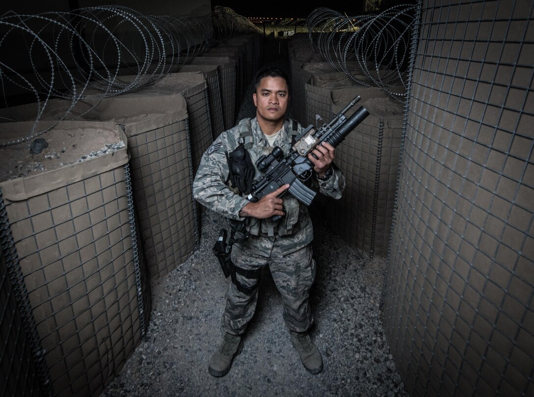 U.S. Air National Guard Staff Sgt. Neil Carranza, a personnel search area lead with the 407th Expeditionary Security Forces Squadron, stands for a photo May 10, 2017, at the 407th Air Expeditionary Group. As a screener, Carranza ensures only authorized individuals are gaining access to the installation and checks for contraband, drugs or illegal items. Carranza, a traditional guardsman with the 254th Security Forces Squadron at Andersen Air Force Base, Guam, deployed in support of Operation Inherent Resolve. (U.S. Air Force photo by Staff Sgt. Alexander W. Riedel)