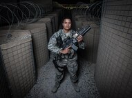 U.S. Air National Guard Staff Sgt. Neil Carranza, a personnel search area lead with the 407th Expeditionary Security Forces Squadron, stands for a photo May 10, 2017, at the 407th Air Expeditionary Group. As a screener, Carranza ensures only authorized individuals are gaining access to the installation and checks for contraband, drugs or illegal items. Carranza, a traditional guardsman with the 254th Security Forces Squadron at Andersen Air Force Base, Guam, deployed in support of Operation Inherent Resolve. (U.S. Air Force photo by Staff Sgt. Alexander W. Riedel)
