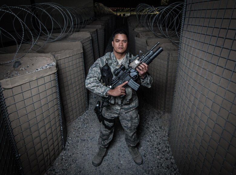 U.S. Air National Guard Staff Sgt. Neil Carranza, a personnel search area lead with the 407th Expeditionary Security Forces Squadron, stands for a photo May 10, 2017, at the 407th Air Expeditionary Group. As a screener, Carranza ensures only authorized individuals are gaining access to the installation and checks for contraband, drugs or illegal items. Carranza, a traditional guardsman with the 254th Security Forces Squadron at Andersen Air Force Base, Guam, deployed in support of Operation Inherent Resolve. (U.S. Air Force photo by Staff Sgt. Alexander W. Riedel)