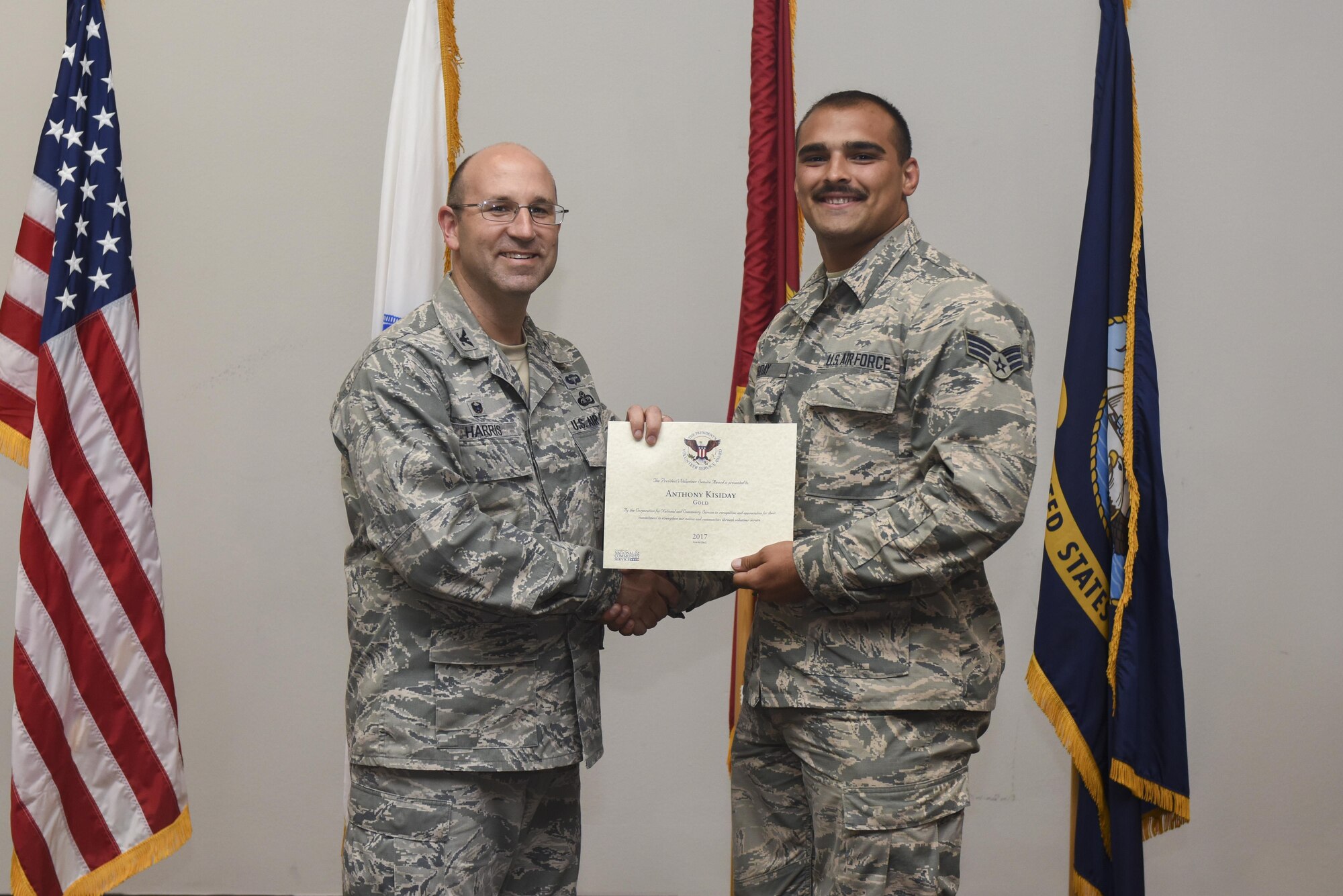 U.S. Air Force Airman 1st Class Anthony Kisiday, 17th Communications Squadron network operations technician, receives the President’s Volunteer Service Award Gold medal from Col. Christopher Harris, 17th Mission Support Group Commander, at the Event Center on Goodfellow Air Force Base, Texas, June 1, 2017. The gold awards recognizes 500 or more volunteer hours to the local community. (U.S. Air Force photo by Airman 1st Class Chase Sousa/Released)