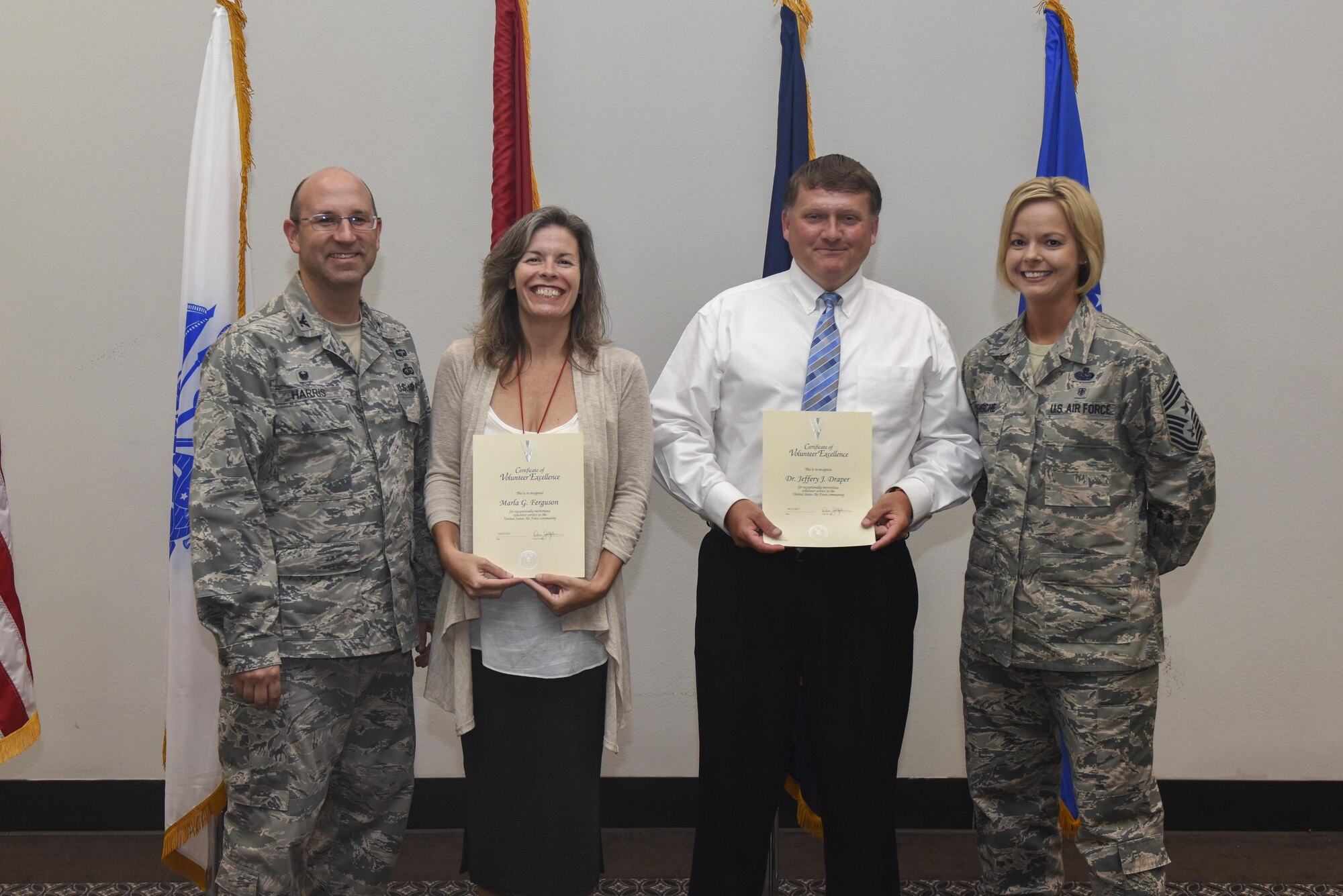 U.S. Air Force Col. Christopher Harris, 17th Mission Support Group Commander and Chief Master Sergeant Bobbie Riensche, 17th Training Wing command chief, present the Volunteer Excellence Award to Marla Ferguson, 17th Force Support Squadron and Jeffrey Draper, 17th Training Support Squadron at the Event Center on Goodfellow Air Force Base, Texas, June 1, 2017. The award is for exceptionally meritorious volunteer service to the United States Air Force community. (U.S. Air Force photo by Airman 1st Class Chase Sousa/Released)