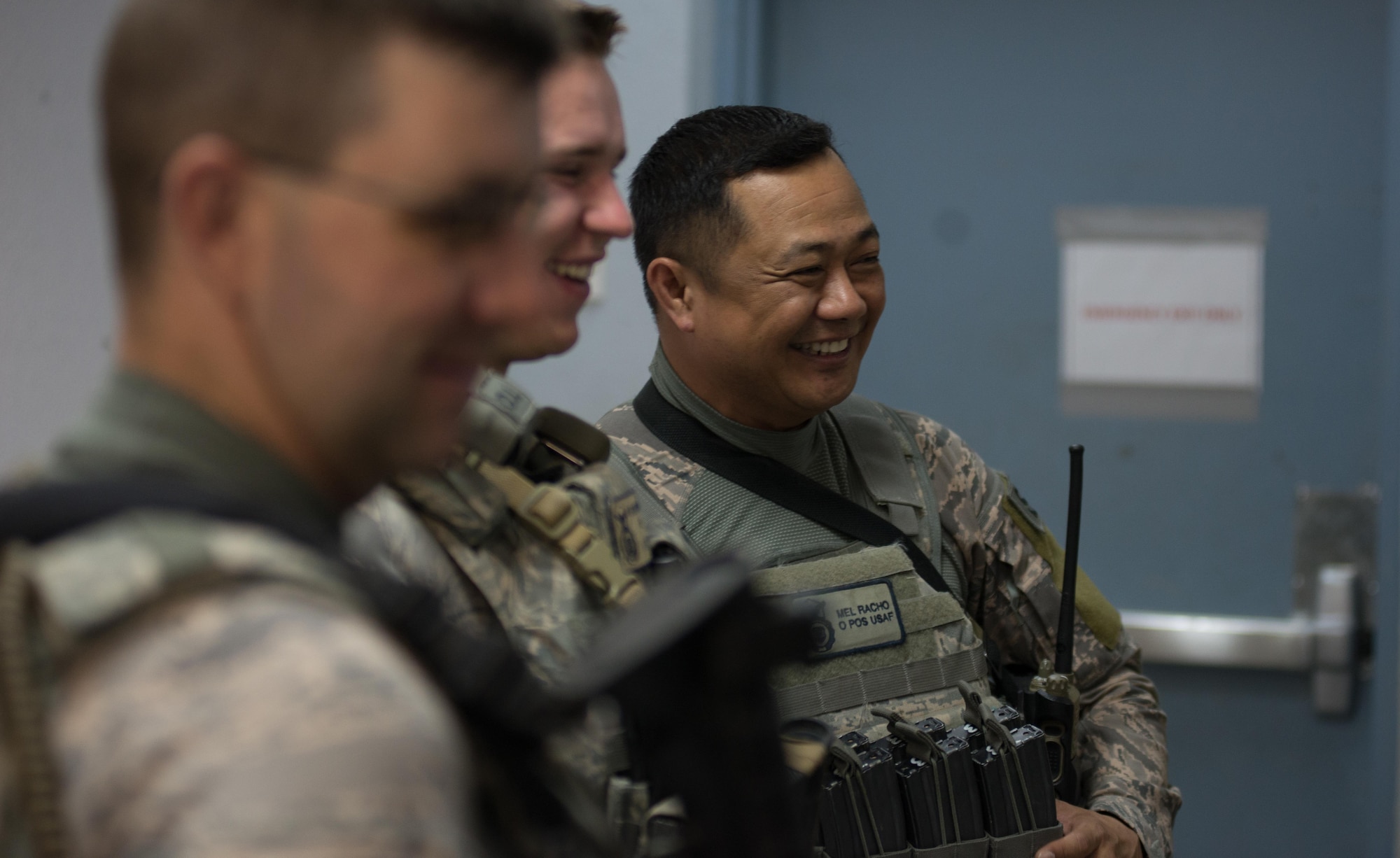 U.S. Air National Guard Staff Sgt. Melquiadez Racho, a patrol team lead with the 407th Expeditionary Security forces Squadron, shares a moment of jokes with his wingmen before shift begin May 13, 2017, in Southwest Asia. Racho is a traditional guardsman deployed from the 254th Security Forces Squadron at Andersen Air Force Base, Guam. When not on Air Force orders, Racho serves as a police instructor with the Department of Defense on Guam. He deployed with fellow ANG members. (U.S. Air Force photo by Staff Sgt. Alexander W. Riedel)