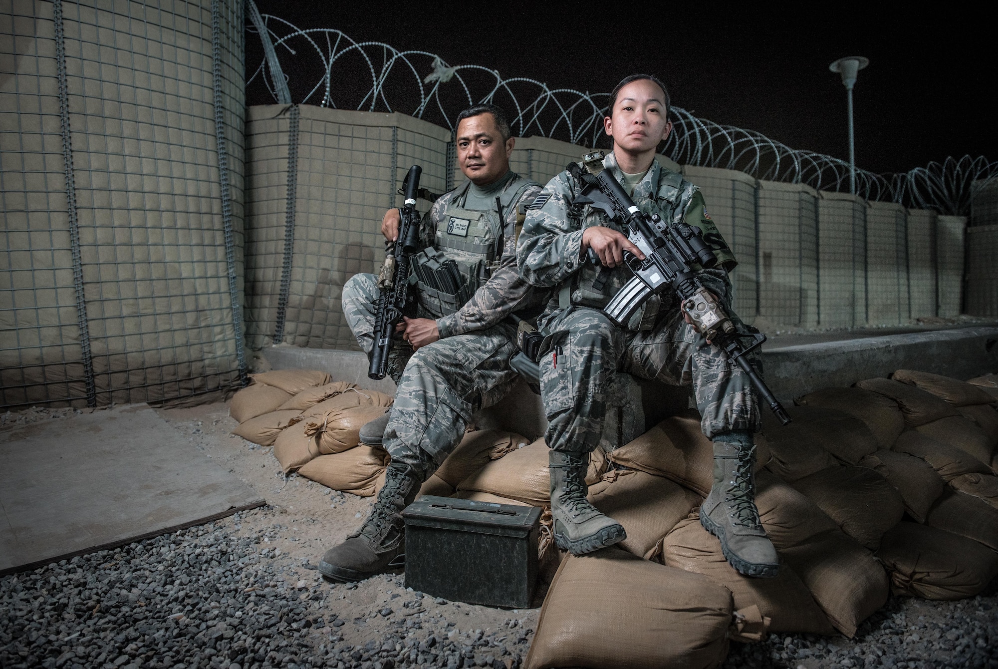 U.S. Air National Guard Staff Sgt. Melquiadez Racho, left, and Tech. Sgt. Renada Taitingfong, both security forces team leads with the 407th Expeditionary Security forces Squadron, sit for a photo May 13, 2017, in Southwest Asia. Racho and Taitingong are guardsmen deployed from the 254th Security Forces Squadron at Andersen Air Force Base, Guam. As part of integrated base defense, the Airmen perform perimeter patrols, vehicle search and personnel screening duties in support of coalition operations against ISIS. (U.S. Air Force photo by Staff Sgt. Alexander W. Riedel)