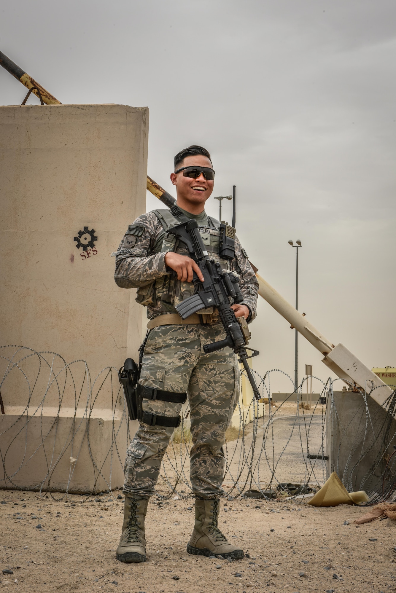 U.S. Air National Guard Airman 1st Class Randall Diego, a security forces member with the 407th Expeditionary Security Forces Squadron, smiles for a photo May 13, 2017, in Southwest Asia. Randall is a member of the 254th Security Forces Squadron at Andersen Air Force Base and volunteered for his first deployment right out of technical training. He is part of a team of Guam service members who deployed to the 407th AEG in support of Operation Inherent Resolve. (U.S. Air Force photo by Senior Airman Ramon Adelan)